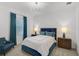 Well-lit bedroom with white walls, blue accents, and classic furniture at 8261 Grande Shores Dr, Sarasota, FL 34240