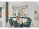 Bright breakfast nook features a glass table, comfortable seating, and views of the pool area at 8261 Grande Shores Dr, Sarasota, FL 34240