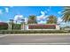 Welcoming entrance sign for Lakehouse Cove at Waterside, surrounded by lush landscaping and palm trees at 8261 Grande Shores Dr, Sarasota, FL 34240