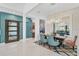 Contemporary dining room with large mirror, modern light fixture, and beautiful accent wall at 8261 Grande Shores Dr, Sarasota, FL 34240