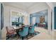 Elegant dining room featuring modern lighting, a large mirror, and stylish seating at 8261 Grande Shores Dr, Sarasota, FL 34240
