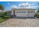 Beautiful home with a spacious three-car garage, meticulously landscaped yard and paver driveway at 8261 Grande Shores Dr, Sarasota, FL 34240