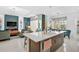 Open kitchen with stainless appliances, a large island, and views of the living area and breakfast nook at 8261 Grande Shores Dr, Sarasota, FL 34240