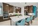 The gourmet kitchen features a large island, stainless steel appliances, and sleek cabinetry at 8261 Grande Shores Dr, Sarasota, FL 34240