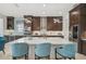 The gourmet kitchen features a large island, stainless steel appliances, and sleek cabinetry at 8261 Grande Shores Dr, Sarasota, FL 34240