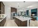 Open kitchen featuring stainless steel appliances, a large island, and seamless flow to the living spaces at 8261 Grande Shores Dr, Sarasota, FL 34240