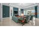 Spacious living room boasts tile floors, stylish decor, and large windows for natural light and a view of the pool at 8261 Grande Shores Dr, Sarasota, FL 34240