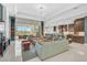 Bright open-concept living room with large windows, modern furnishings, and seamless flow to the outdoor living space at 8261 Grande Shores Dr, Sarasota, FL 34240