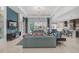 Open-concept living room with modern design, flowing into the kitchen and overlooking the pool area at 8261 Grande Shores Dr, Sarasota, FL 34240