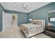 A serene main bedroom with a colorful bedspread, contemporary light fixture, and an ensuite bathroom at 8261 Grande Shores Dr, Sarasota, FL 34240