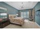 Well-appointed bedroom with a stylish ceiling fan, large windows, and modern furnishings at 8261 Grande Shores Dr, Sarasota, FL 34240