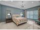 Tranquil bedroom featuring elegant lighting, contemporary decor, and ample natural light at 8261 Grande Shores Dr, Sarasota, FL 34240