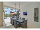 Stylish outdoor dining area overlooking the pool, featuring a modern table setting and screened enclosure for comfort at 8261 Grande Shores Dr, Sarasota, FL 34240