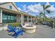 Comfortable outdoor patio with modern furniture and a stone fire pit at the Lakehouse Cove community at 8261 Grande Shores Dr, Sarasota, FL 34240