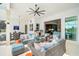 This covered patio offers stylish outdoor living with travertine floors, a bar, and comfortable seating areas at 8261 Grande Shores Dr, Sarasota, FL 34240