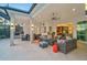Inviting covered patio features comfortable seating, an outdoor kitchen, and travertine flooring for stylish outdoor living at 8261 Grande Shores Dr, Sarasota, FL 34240