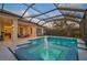 Outdoor screened pool with a fountain spa surrounded by a patio and covered seating area at 8261 Grande Shores Dr, Sarasota, FL 34240