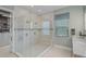 A luxury bathroom featuring a glass enclosed shower with dual shower heads next to the walk-in closet at 8261 Grande Shores Dr, Sarasota, FL 34240