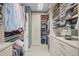 Organized walk-in closet with custom shelving and storage for clothing, shoes, and accessories at 8261 Grande Shores Dr, Sarasota, FL 34240