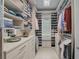A spacious walk-in closet with custom shelving and storage solutions for organizing clothes, shoes, and accessories at 8261 Grande Shores Dr, Sarasota, FL 34240