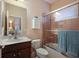 Cozy bathroom featuring a shower-tub combo with glass doors and a convenient toilet and vanity at 176 Avens Dr, Nokomis, FL 34275