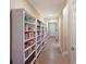 Bright hallway featuring built-in bookshelves filled with books, offering ample storage and charm at 176 Avens Dr, Nokomis, FL 34275