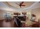 Open-concept living room and kitchen with hardwood floors, neutral walls and a ceiling fan at 176 Avens Dr, Nokomis, FL 34275