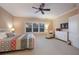 Bright main bedroom featuring neutral walls, plush carpeting, and a large window at 176 Avens Dr, Nokomis, FL 34275