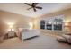 Bright main bedroom featuring neutral walls, plush carpeting, and a large window at 176 Avens Dr, Nokomis, FL 34275