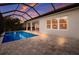 Beautiful pool and patio area with outdoor seating under a screened enclosure, perfect for entertaining at 176 Avens Dr, Nokomis, FL 34275