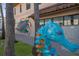 Unique seahorse statue adding coastal charm, complemented by palm trees and a vibrant mural in the background at 176 Avens Dr, Nokomis, FL 34275