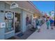 Quaint storefront showcasing boutique items, with a clear view of operating hours and pedestrians nearby at 176 Avens Dr, Nokomis, FL 34275