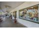 Charming storefront with window displays, a welcoming sign, and pedestrians enjoying the sunny surroundings at 176 Avens Dr, Nokomis, FL 34275