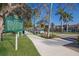 Scenic street view featuring Mediterranean architecture, historical markers, and lush landscaping under a clear sky at 176 Avens Dr, Nokomis, FL 34275