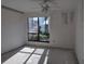 Bedroom with a large window looking out into a garden at 1801 Gulf N Dr # 121, Bradenton Beach, FL 34217