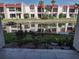 Exterior view of townhouses reflected in a waterway at 1801 Gulf N Dr # 121, Bradenton Beach, FL 34217
