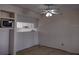 An empty living room with a ceiling fan and a view into the kitchen at 1801 Gulf N Dr # 121, Bradenton Beach, FL 34217