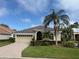 Charming single-story home featuring a well-manicured lawn, brick driveway, and a beautiful tiled roof at 5062 Flagstone Dr, Sarasota, FL 34238