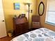 Bedroom featuring a wooden desk, floor lamp, and wicker chair at 515 30Th W Ave # H207, Bradenton, FL 34205