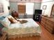 Comfortable bedroom featuring a large bed with decorative pillows and wicker furniture at 515 30Th W Ave # H207, Bradenton, FL 34205