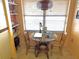 Cozy breakfast nook featuring a glass table, seating for two, and natural light from the window at 515 30Th W Ave # H207, Bradenton, FL 34205