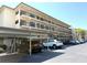 Multi-level condo building showing parking area and black iron railings at 515 30Th W Ave # H207, Bradenton, FL 34205