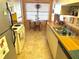 Well-lit kitchen with white appliances and cabinets, showcasing an adjacent dining area with natural light at 515 30Th W Ave # H207, Bradenton, FL 34205