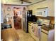 View of the kitchen with white cabinets, appliances, and an adjacent dining area at 515 30Th W Ave # H207, Bradenton, FL 34205