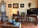Comfortable living room features wood floors, antique decor, and a mounted flatscreen TV at 515 30Th W Ave # H207, Bradenton, FL 34205