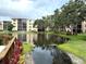 Scenic view of a pond surrounded by lush greenery in a serene residential community at 515 30Th W Ave # H207, Bradenton, FL 34205
