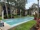 Community shuffleboard court surrounded by lush landscaping at 515 30Th W Ave # H207, Bradenton, FL 34205