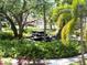 Scenic area with cascading water feature surrounded by lush ferns and tropical landscaping at 515 30Th W Ave # H207, Bradenton, FL 34205