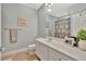 Well-lit bathroom with a white vanity, framed mirror, and decorative accents at 5972 Giardino Ln, Sarasota, FL 34232