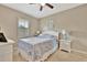 Cozy bedroom featuring neutral walls, carpet, and a ceiling fan for a comfortable living space at 5972 Giardino Ln, Sarasota, FL 34232